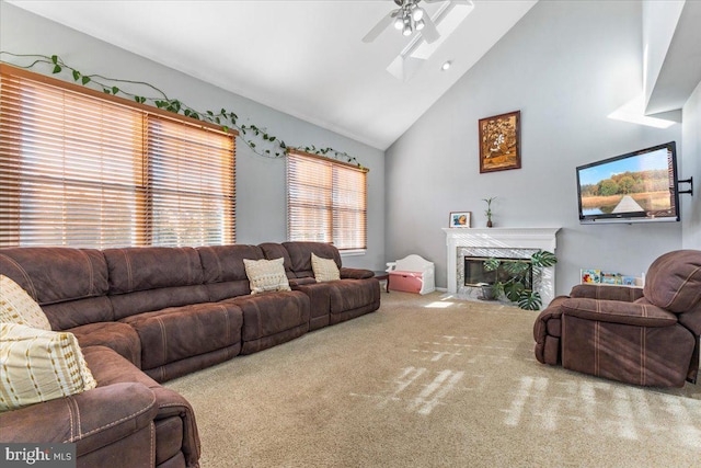 living area featuring carpet floors, a fireplace, high vaulted ceiling, and ceiling fan