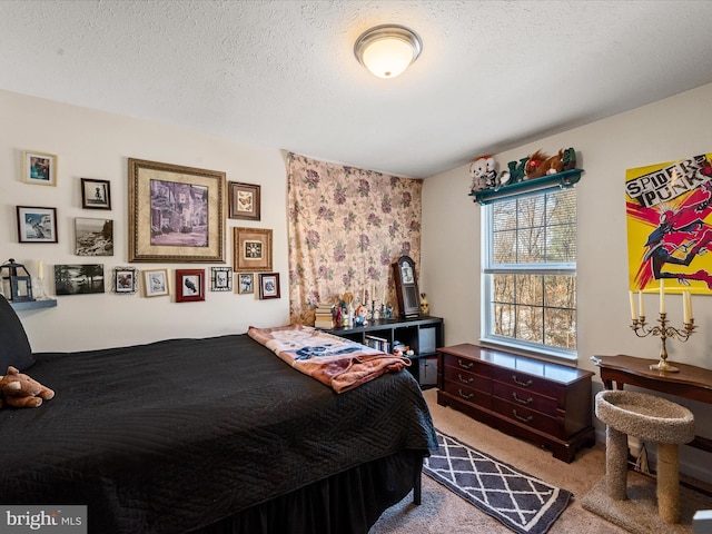 bedroom with light carpet and a textured ceiling