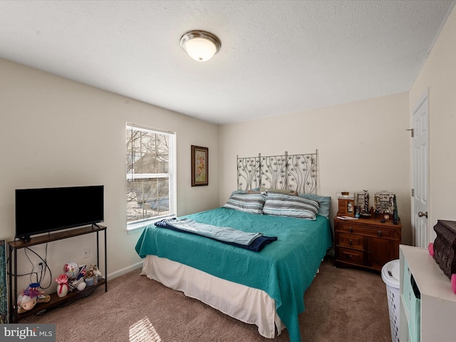 bedroom featuring dark carpet and a textured ceiling