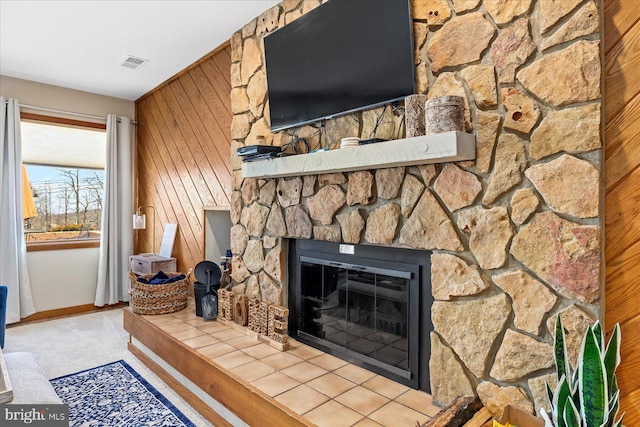 interior details featuring carpet floors, a fireplace, and wood walls