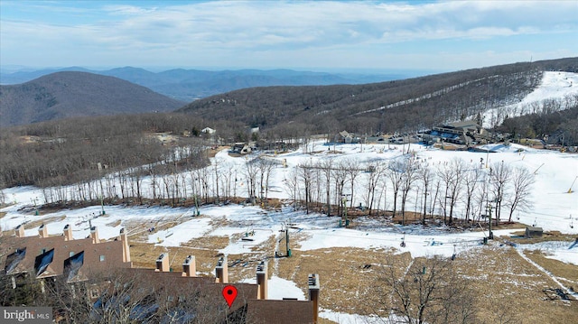 snowy aerial view featuring a mountain view