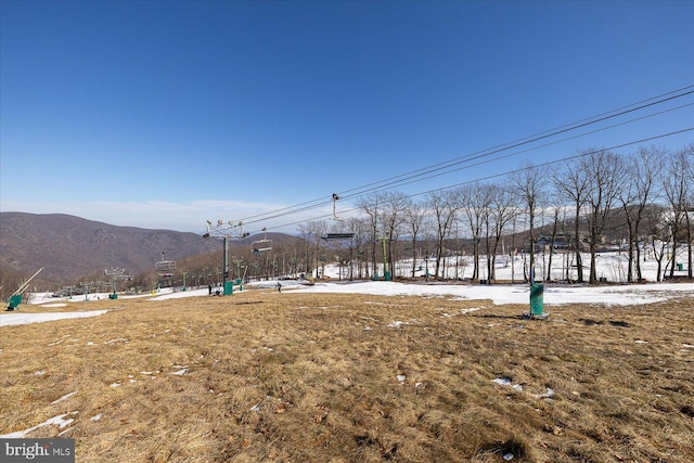 snowy yard with a mountain view