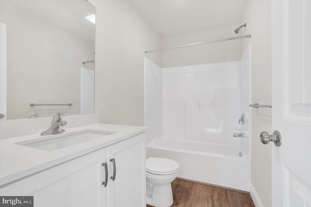 full bathroom featuring vanity, hardwood / wood-style floors, shower / washtub combination, and toilet