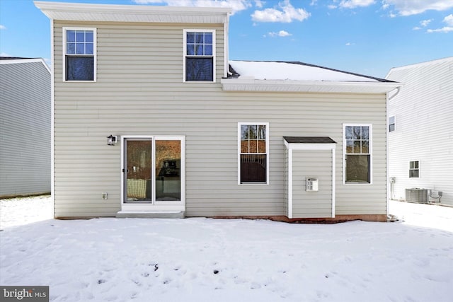 snow covered property with cooling unit