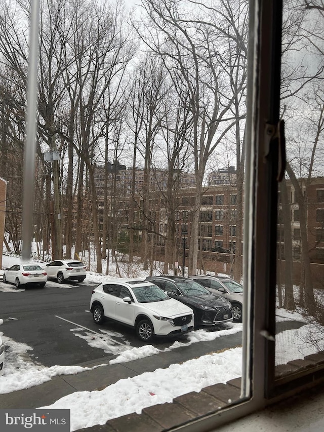 view of snow covered parking