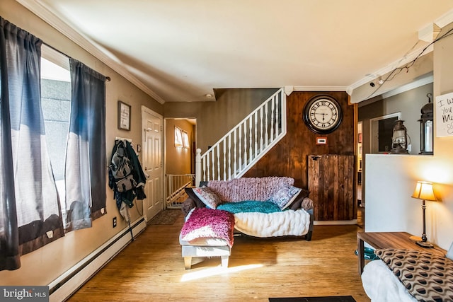 entryway featuring crown molding, hardwood / wood-style floors, baseboard heating, and wood walls