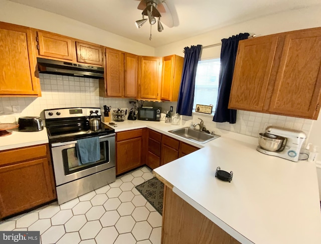 kitchen featuring sink, backsplash, ceiling fan, and stainless steel range with electric stovetop