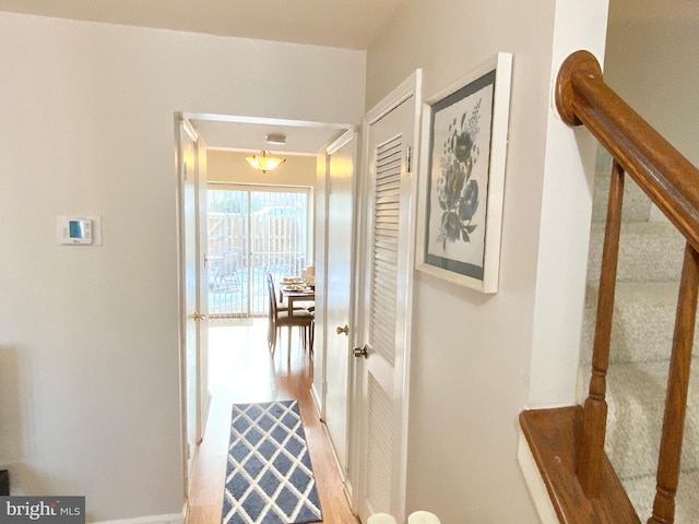 hall with hardwood / wood-style floors