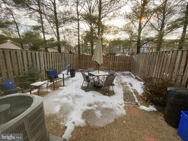 snow covered patio featuring central AC