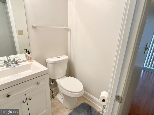 bathroom with vanity, tile patterned flooring, and toilet