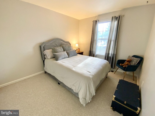 bedroom featuring light carpet