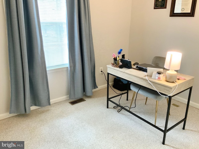 office featuring light colored carpet and plenty of natural light