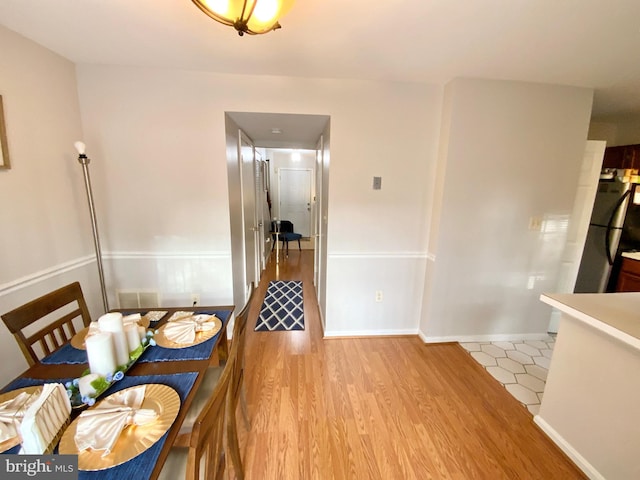 dining area with light wood-type flooring