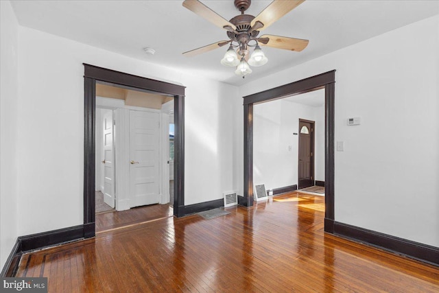 spare room with hardwood / wood-style floors and ceiling fan