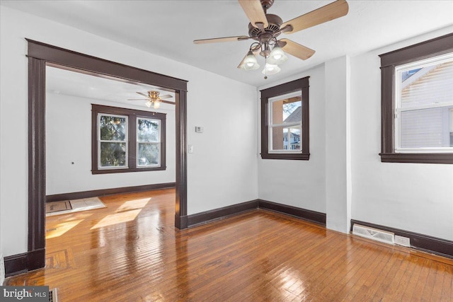 empty room featuring ceiling fan and wood-type flooring