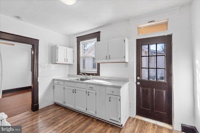 kitchen featuring white cabinetry, sink, tasteful backsplash, and dark hardwood / wood-style floors