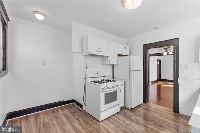 kitchen with tasteful backsplash, white appliances, dark hardwood / wood-style flooring, and white cabinets