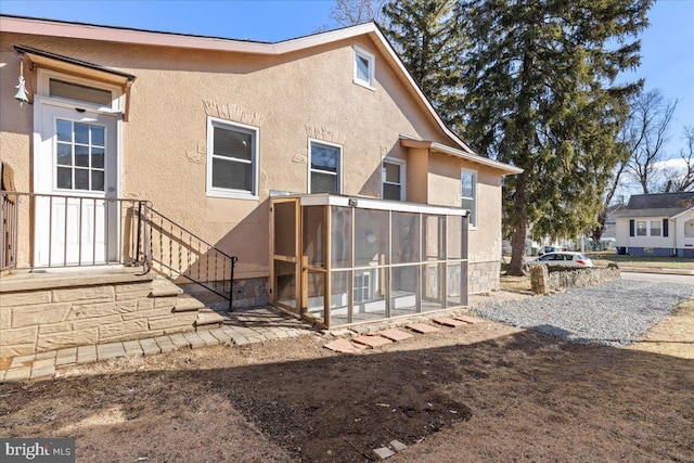 back of house with a sunroom