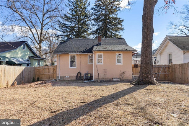 rear view of house featuring central AC unit