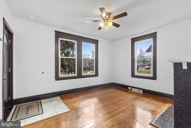 spare room featuring wood-type flooring and ceiling fan