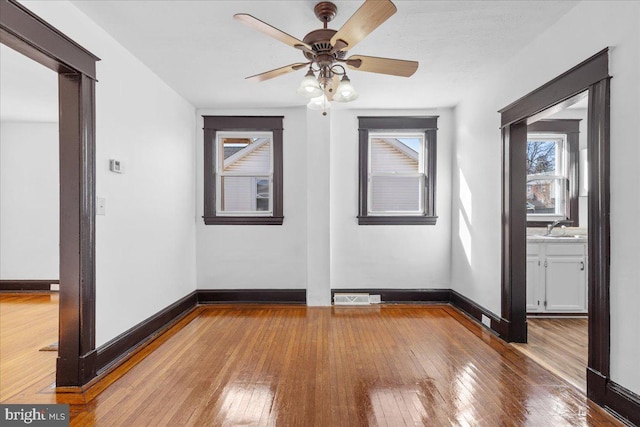 empty room featuring ceiling fan, wood-type flooring, and sink