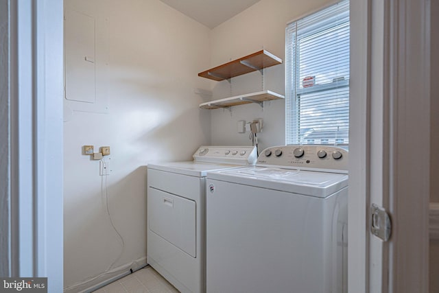 clothes washing area with washing machine and clothes dryer and electric panel