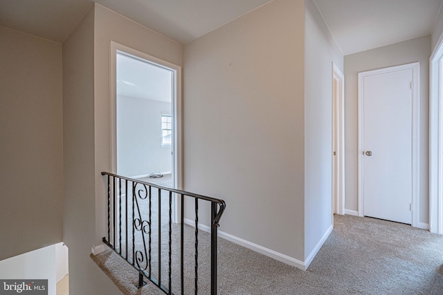 hallway featuring light carpet