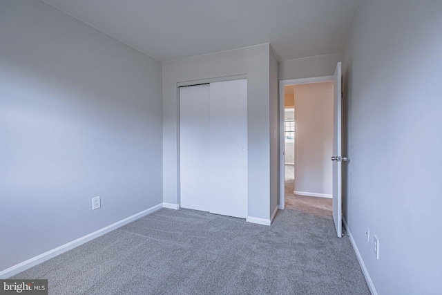 unfurnished bedroom featuring a closet and carpet