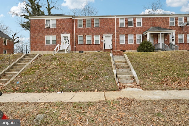 view of property featuring cooling unit and a front yard