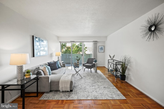 living room with parquet flooring and a textured ceiling