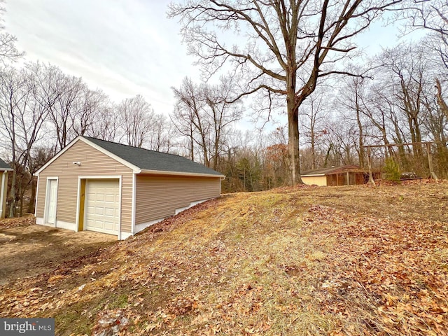 exterior space with an outbuilding and a garage