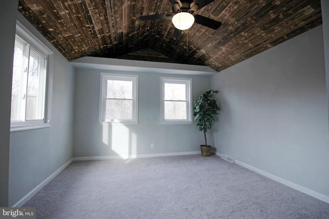 unfurnished room with vaulted ceiling, carpet, wooden ceiling, and ceiling fan