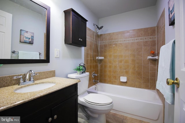 full bathroom with vanity, tiled shower / bath combo, tile patterned floors, and toilet