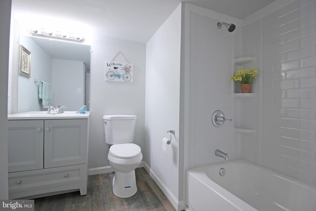 full bathroom featuring hardwood / wood-style flooring, tiled shower / bath, vanity, and toilet