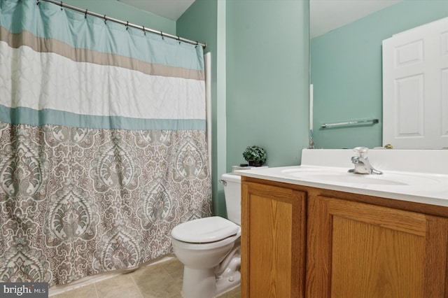 bathroom featuring vanity, toilet, and tile patterned flooring