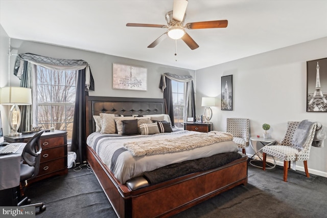 bedroom with dark colored carpet and ceiling fan