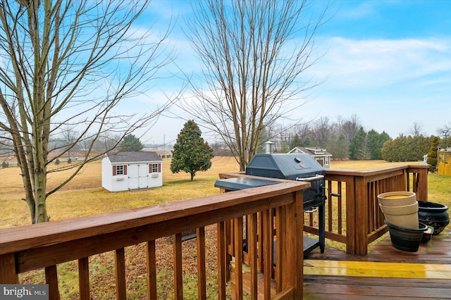 wooden terrace featuring a storage unit and a lawn