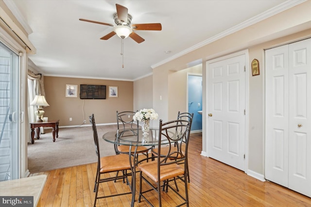 dining room featuring crown molding, ceiling fan, and light wood-type flooring