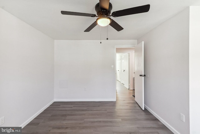 unfurnished room with wood finished floors and baseboards