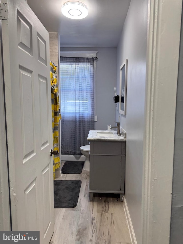 full bath with wood finished floors, vanity, toilet, and a shower with curtain