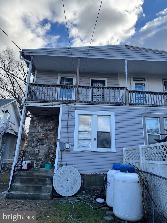 rear view of property featuring a balcony