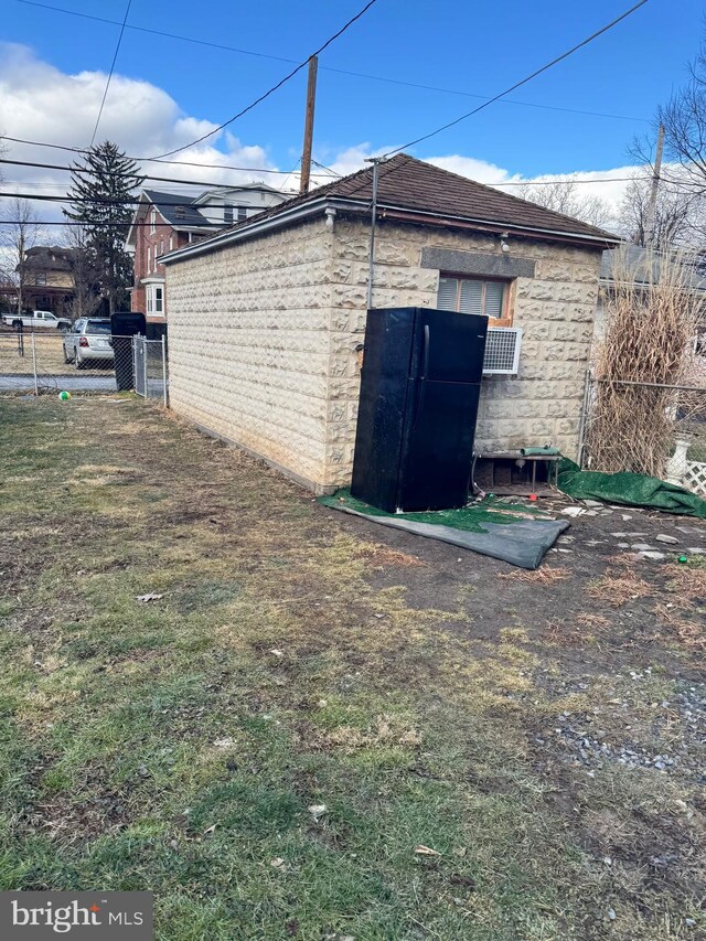 view of outbuilding with fence