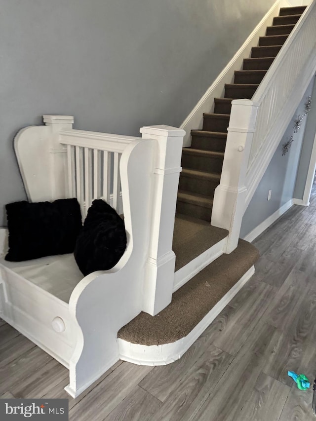 staircase featuring wood finished floors