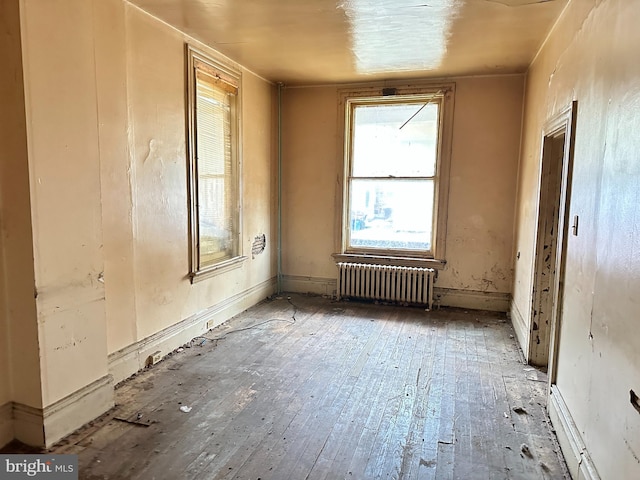 miscellaneous room with radiator and hardwood / wood-style floors