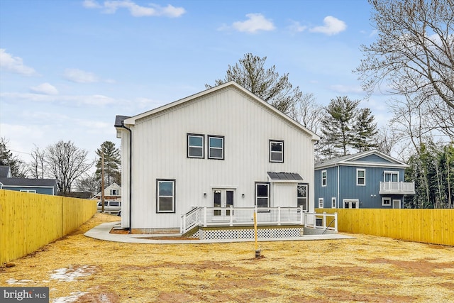 rear view of house with french doors and a deck