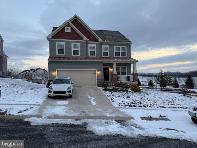 view of front of house featuring a garage and covered porch