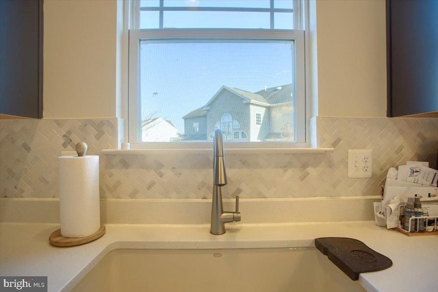 interior details featuring tasteful backsplash and sink