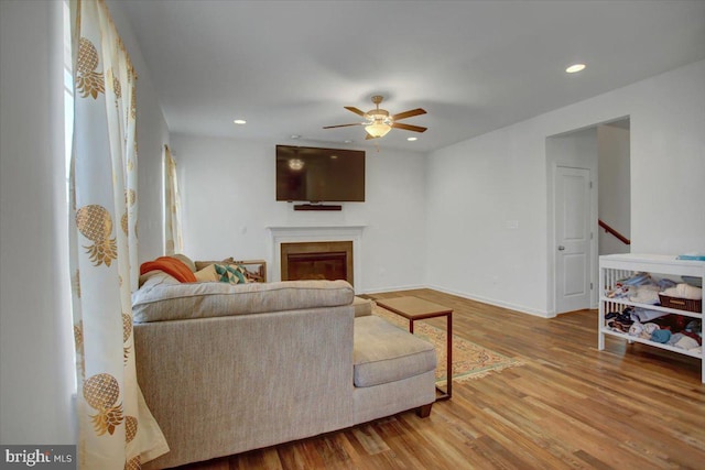 living room with hardwood / wood-style flooring and ceiling fan