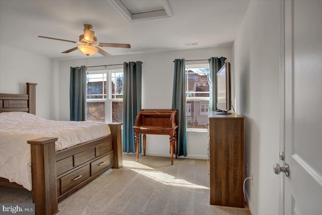 carpeted bedroom with ceiling fan and multiple windows