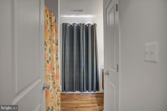 bathroom with hardwood / wood-style flooring